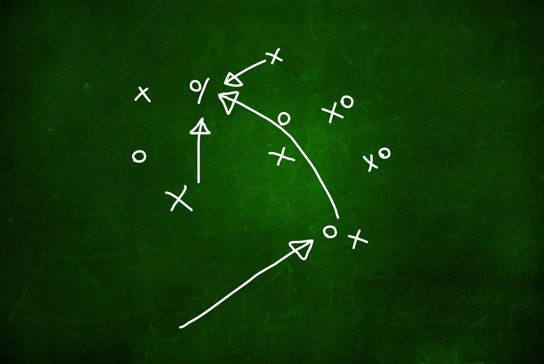 Football play strategy drawn out on a chalk board
