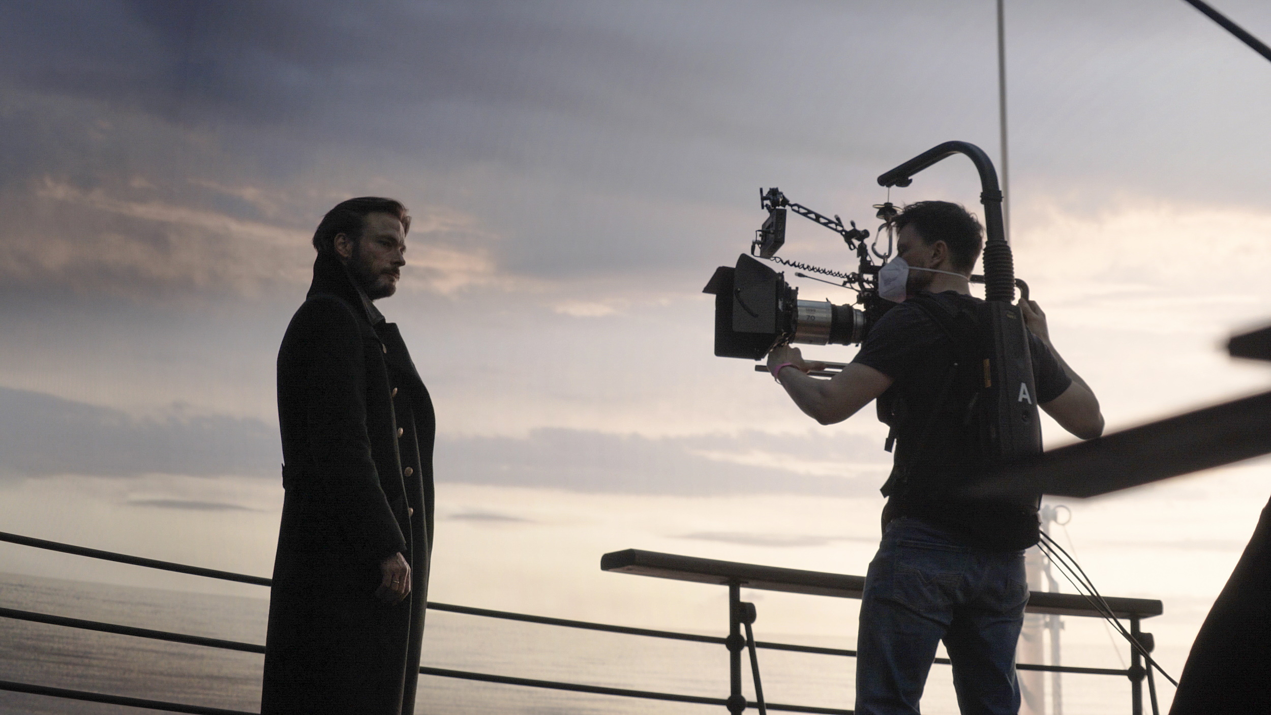 Close up of an actor and camera operator against an LCD wall.