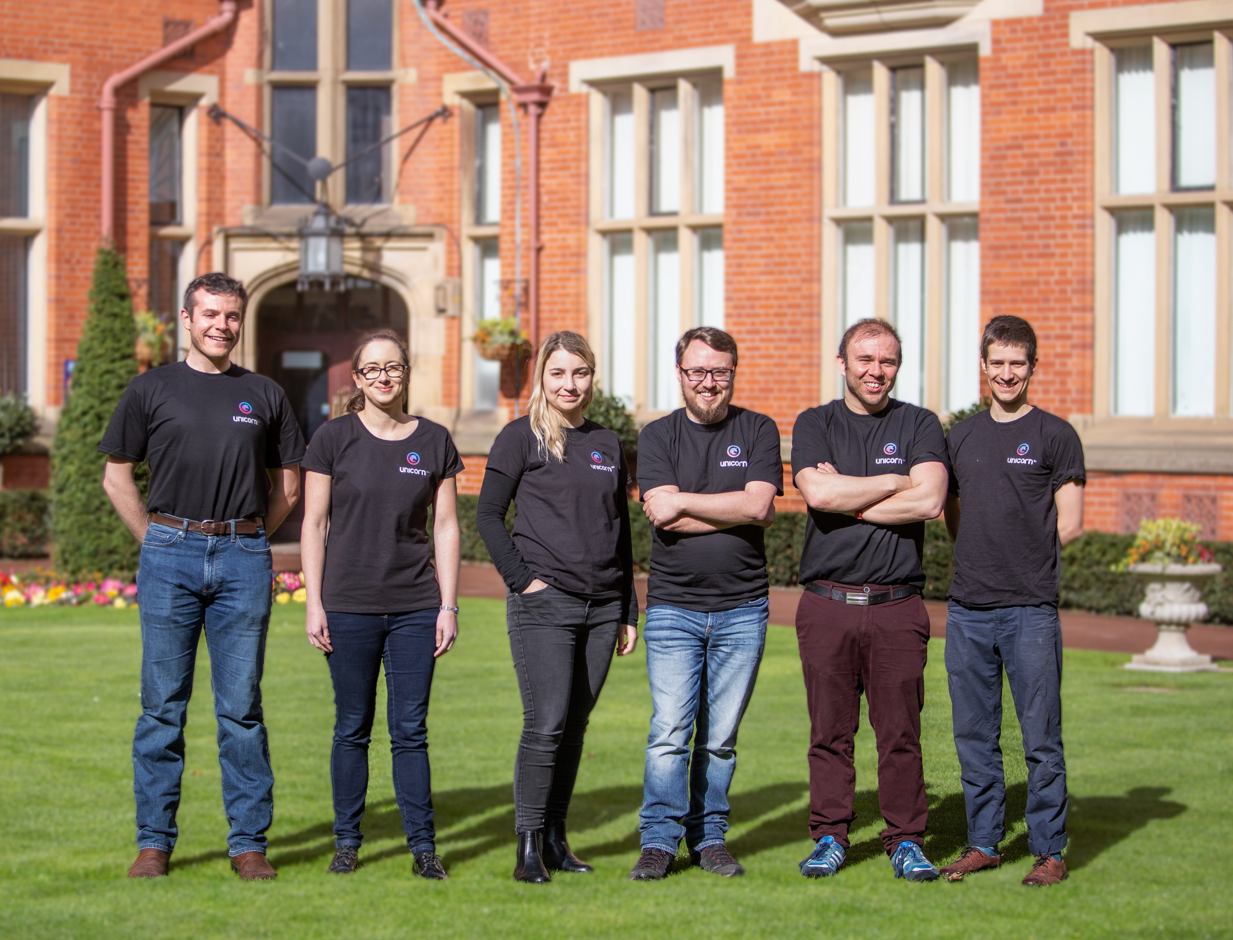 The Unicorn Bio team in a field outside their lab.