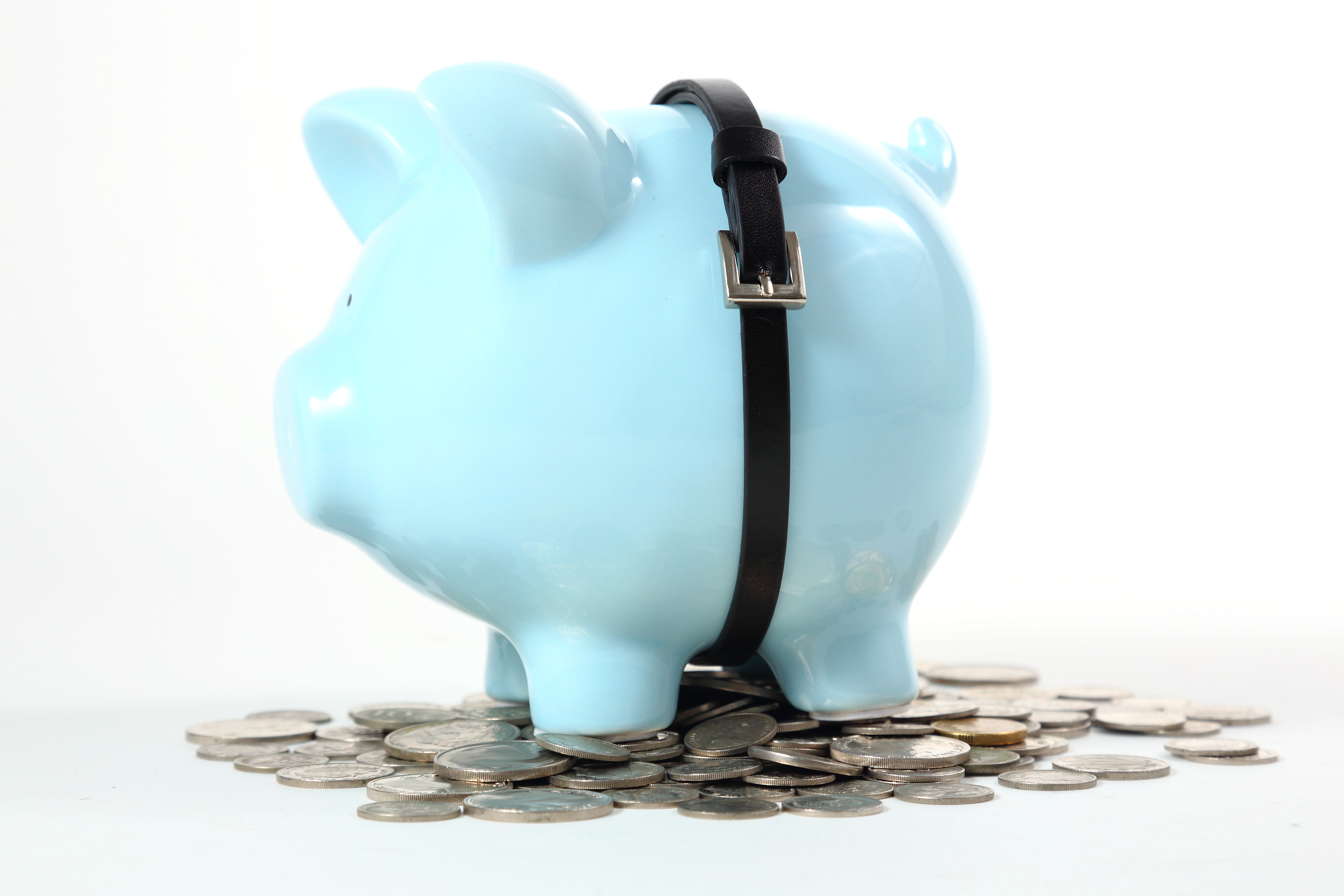 Image of a blue piggybank wearing a belt atop a pile of coins.