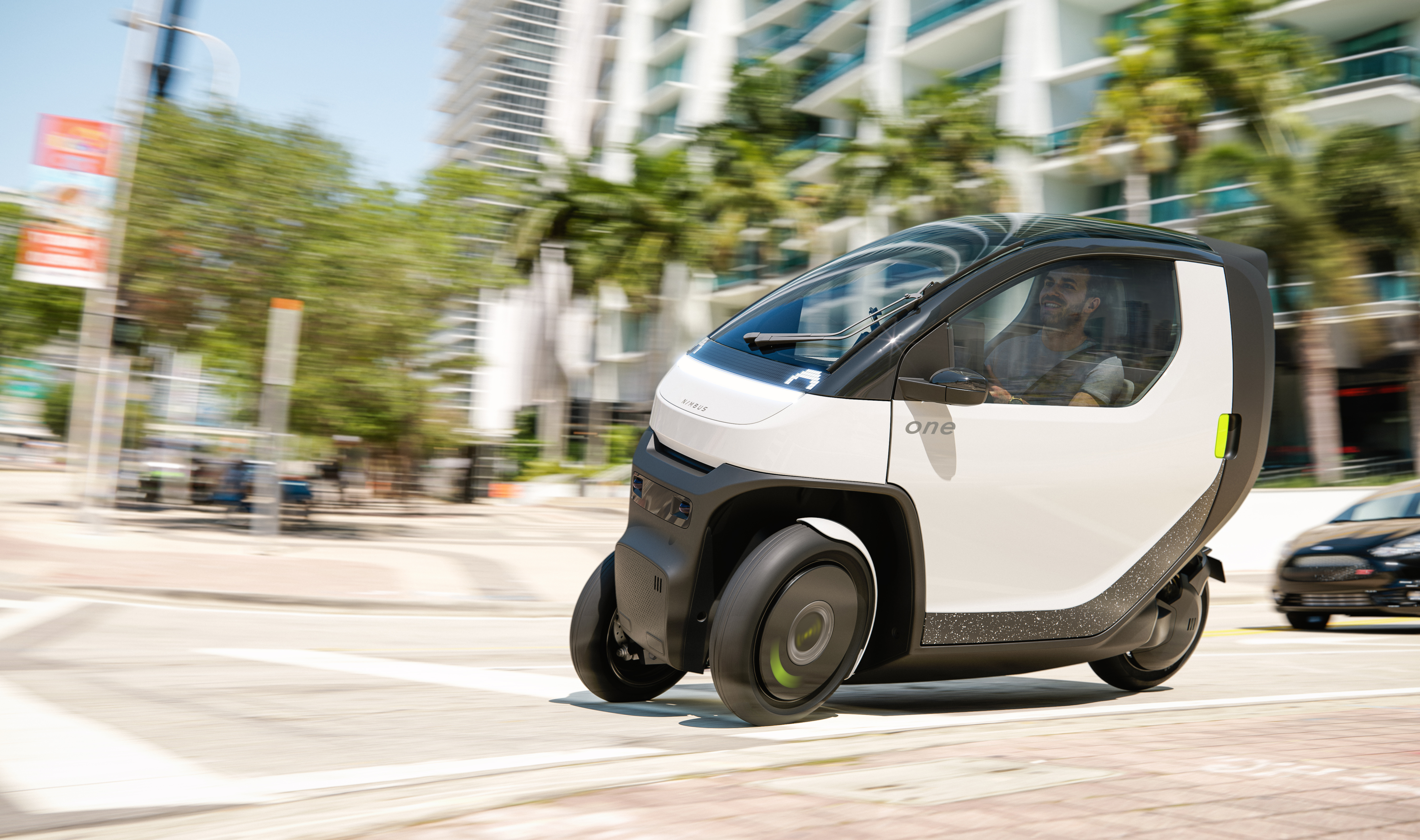 Nimbus One tilting 3-wheel tiny EV driving in city