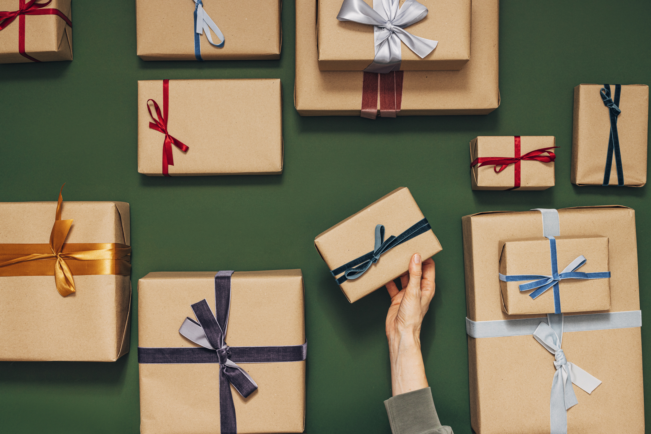 hand holding multiple gift-wrapped boxes. unbundled databases