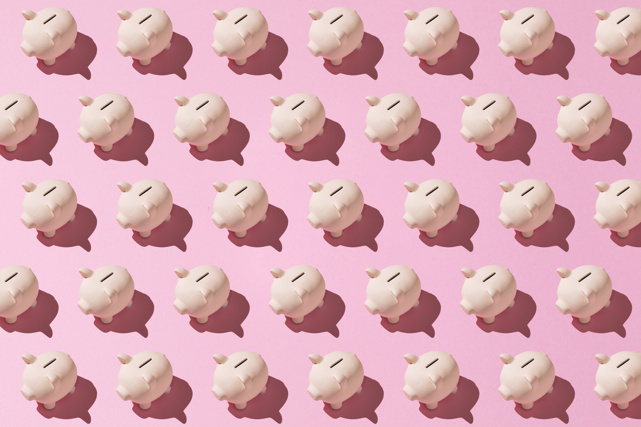 Little pink ceramic piggy bank pattern on pink background. Concept of saving money, savings.