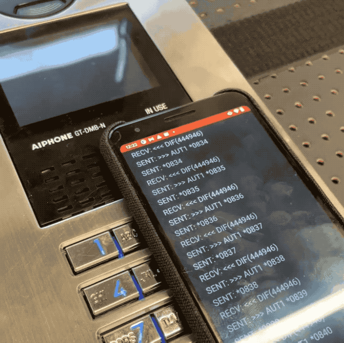 An animated GIF of the test lab set up with an Android phone that's rapidly cycling through every permutation of four-digit codes.