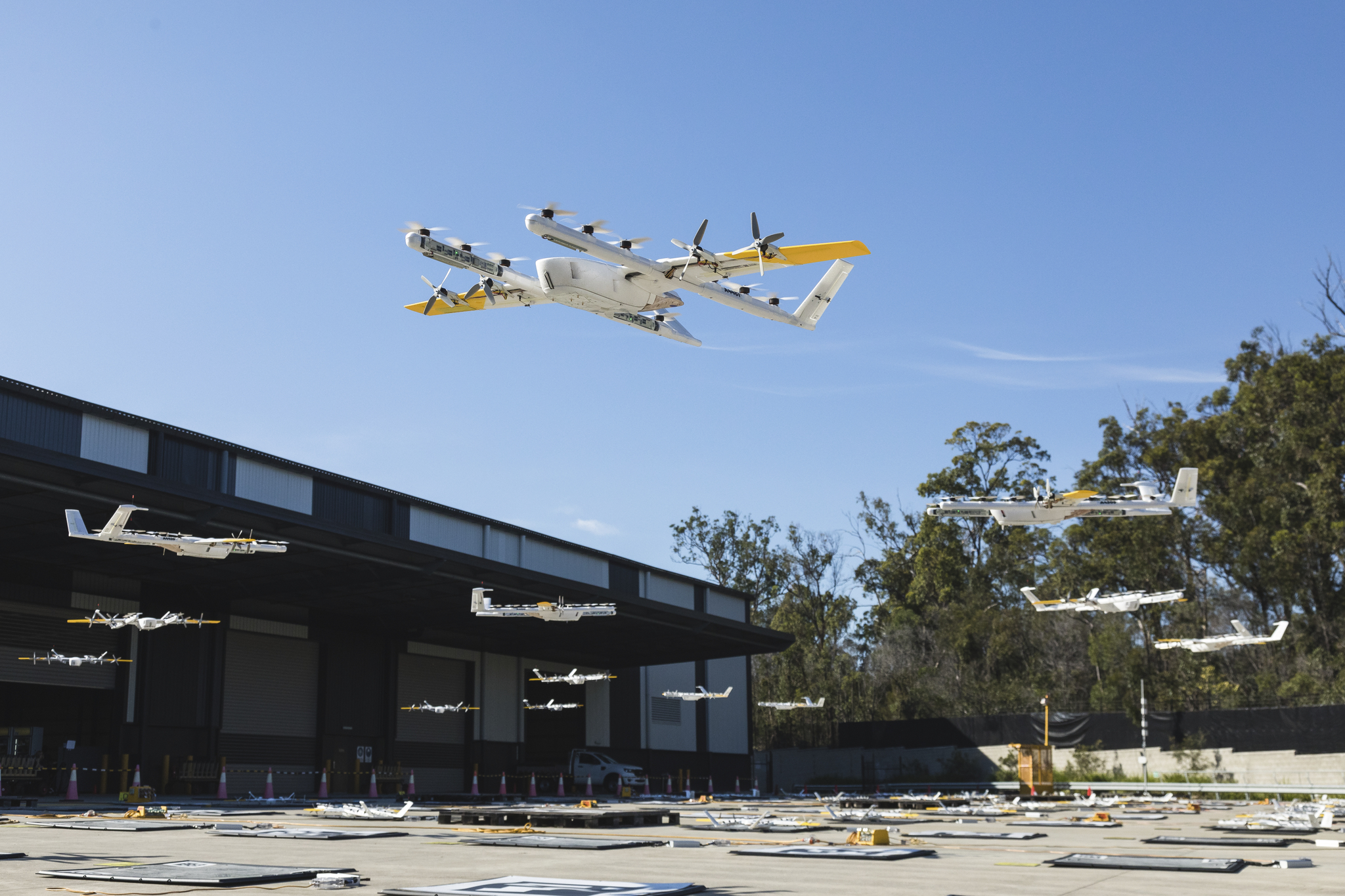 Multiple drones hovering over courtyard